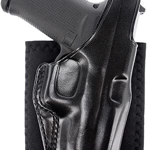 Black pistol in leather gun holster.