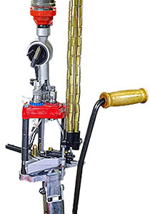 Gun reloading press machine with handle and tubes.