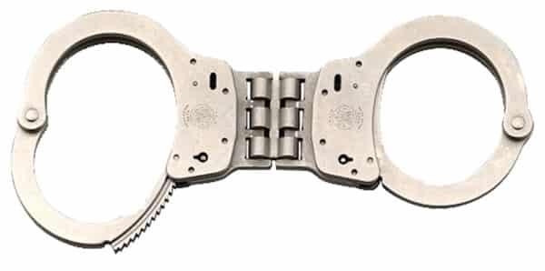 Metal handcuffs open on white background.