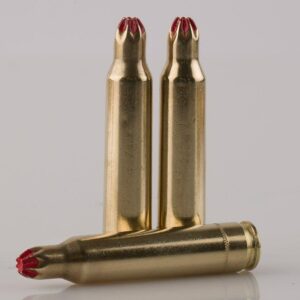 Three crimped brass blank cartridges standing and lying down.