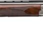 Over-under shotgun with wooden stock and metal engraving.