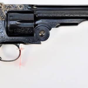 Engraved revolver with wooden handle on display