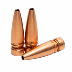 Three copper bullet casings standing upright