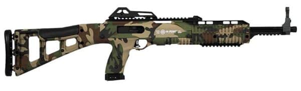Camouflage rifle with scope, black stock, side view.