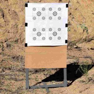 Shooting target on outdoor stand with four bullseyes.