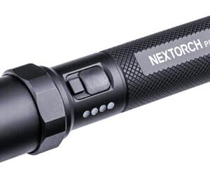 Black tactical flashlight, side view close-up.
