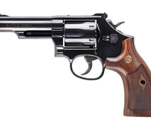 Revolver handgun with wooden grip on white background.