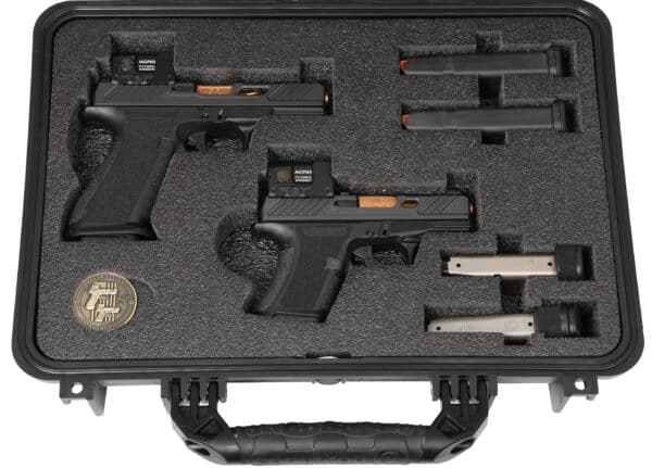 Carrying case with two handguns and accessories.