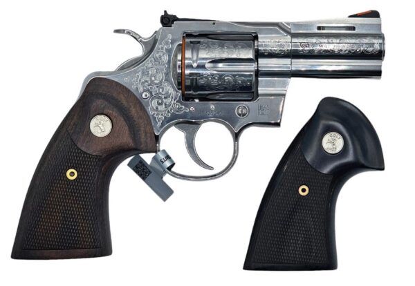 Engraved revolver with two grips displayed.