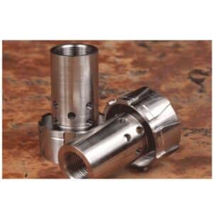 Two metal cylindrical machine parts on table