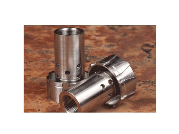 Two metal cylindrical machine parts on table