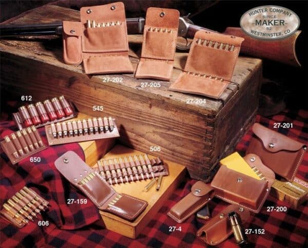 Leather ammo holders and shotgun shells displayed on crate.