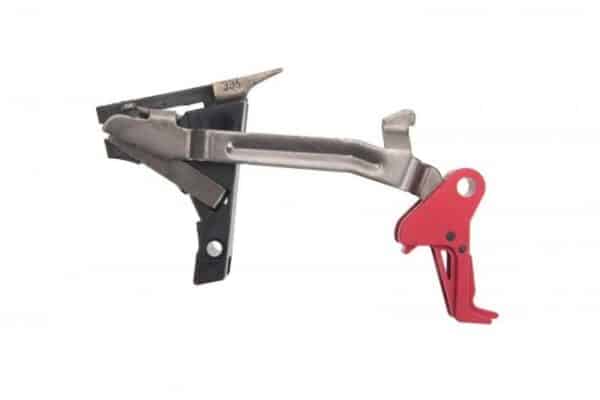Red and silver rifle trigger assembly on white background.